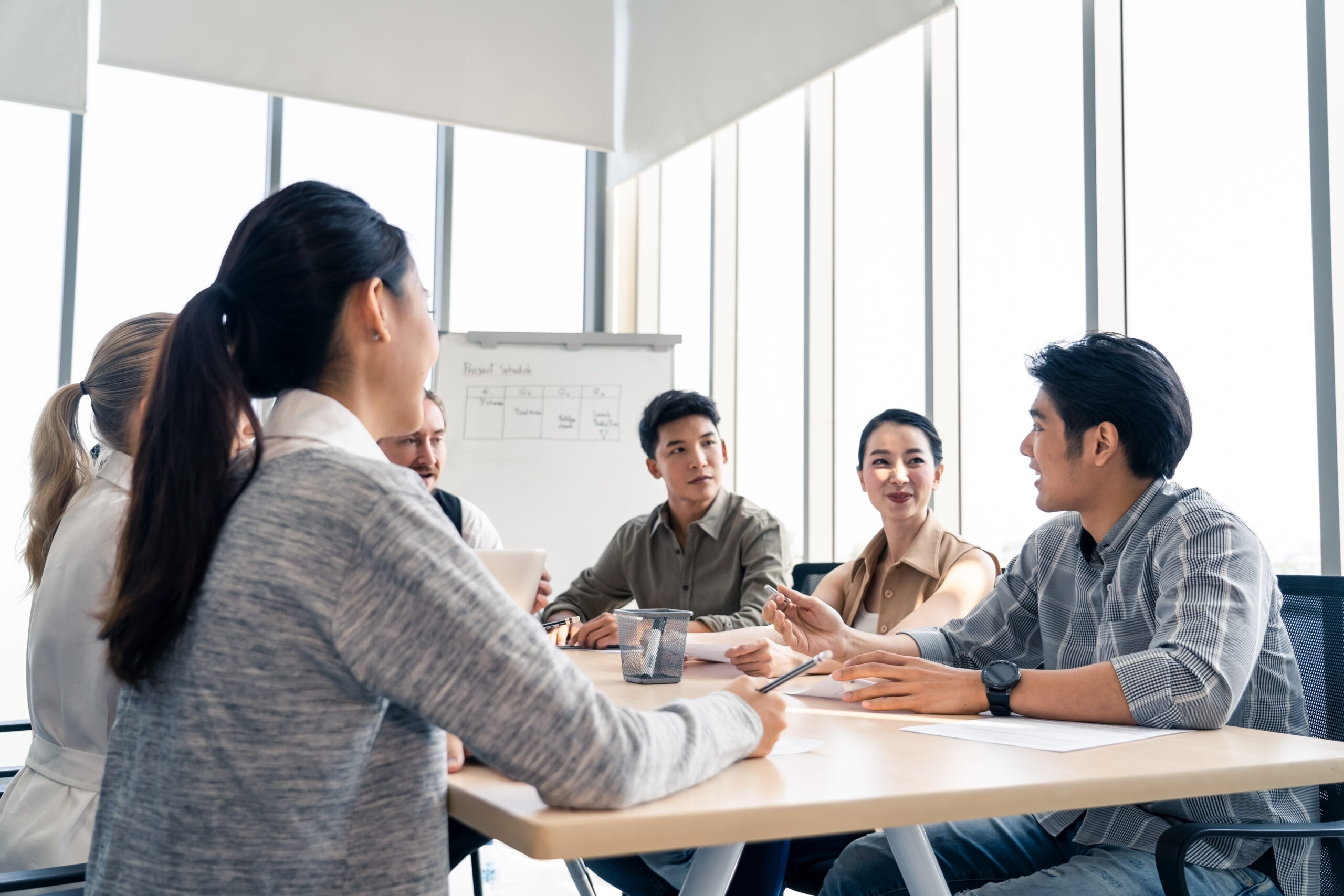 Asian man and team working brainstorm to solve problem and presentation new idea. People discuss and smile on new challenge topic in meeting room. Business finance and communication planning concept.